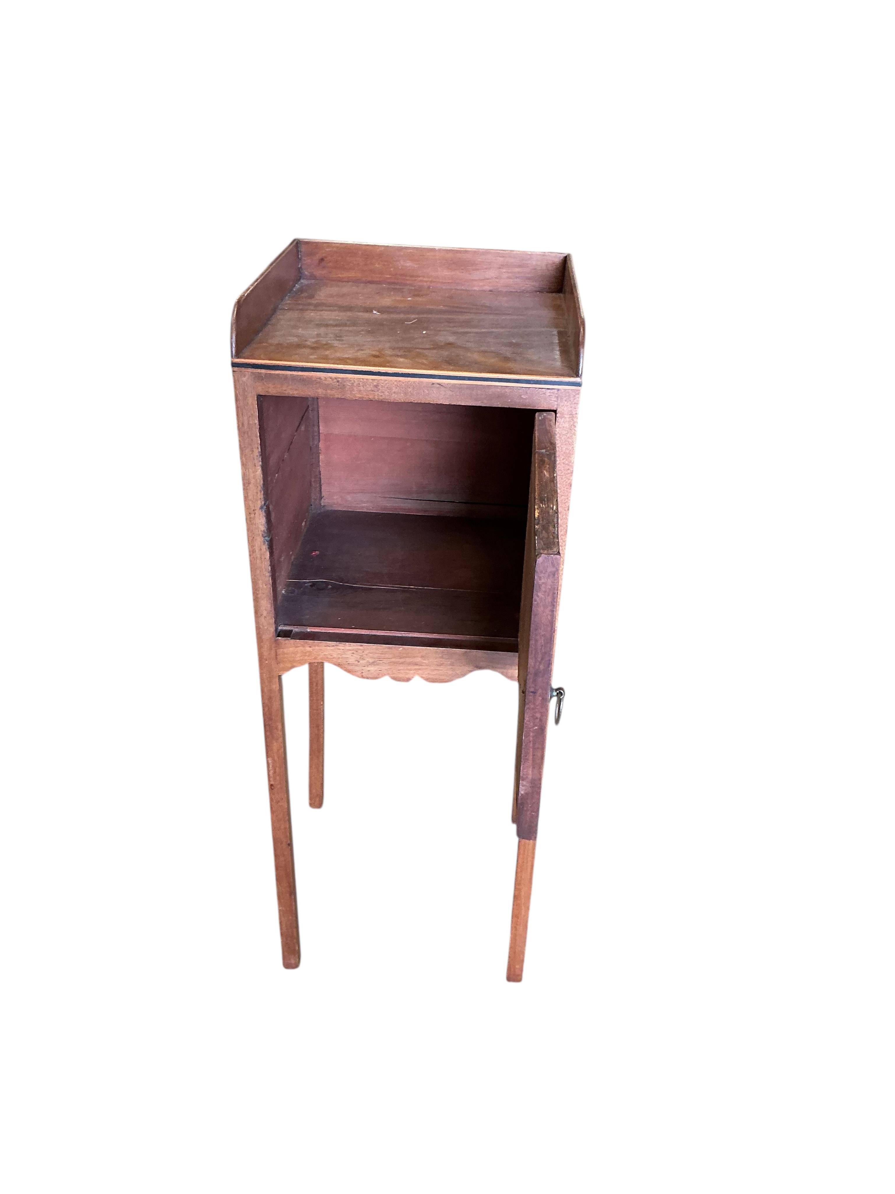 A George III mahogany bow front corner washstand, pot cupboard and an Edwardian plant stand